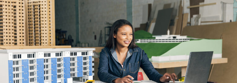 smiling-african-american-lady-with-laptop-model-building